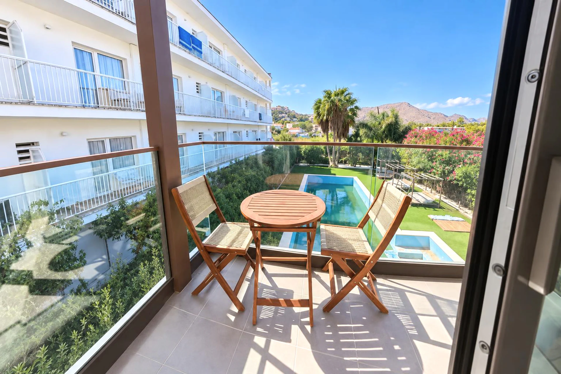 Balcony with seating and communal pool view